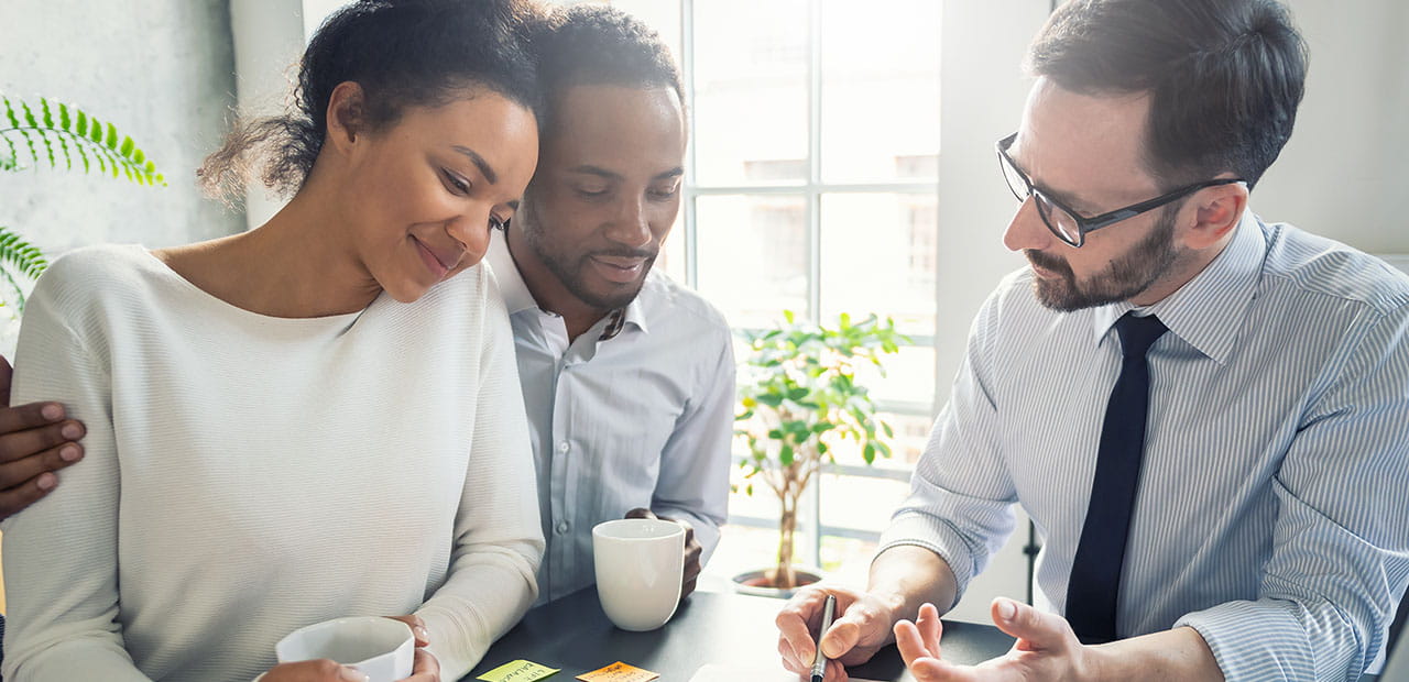 Couple consults with a lawyer or insurance agent